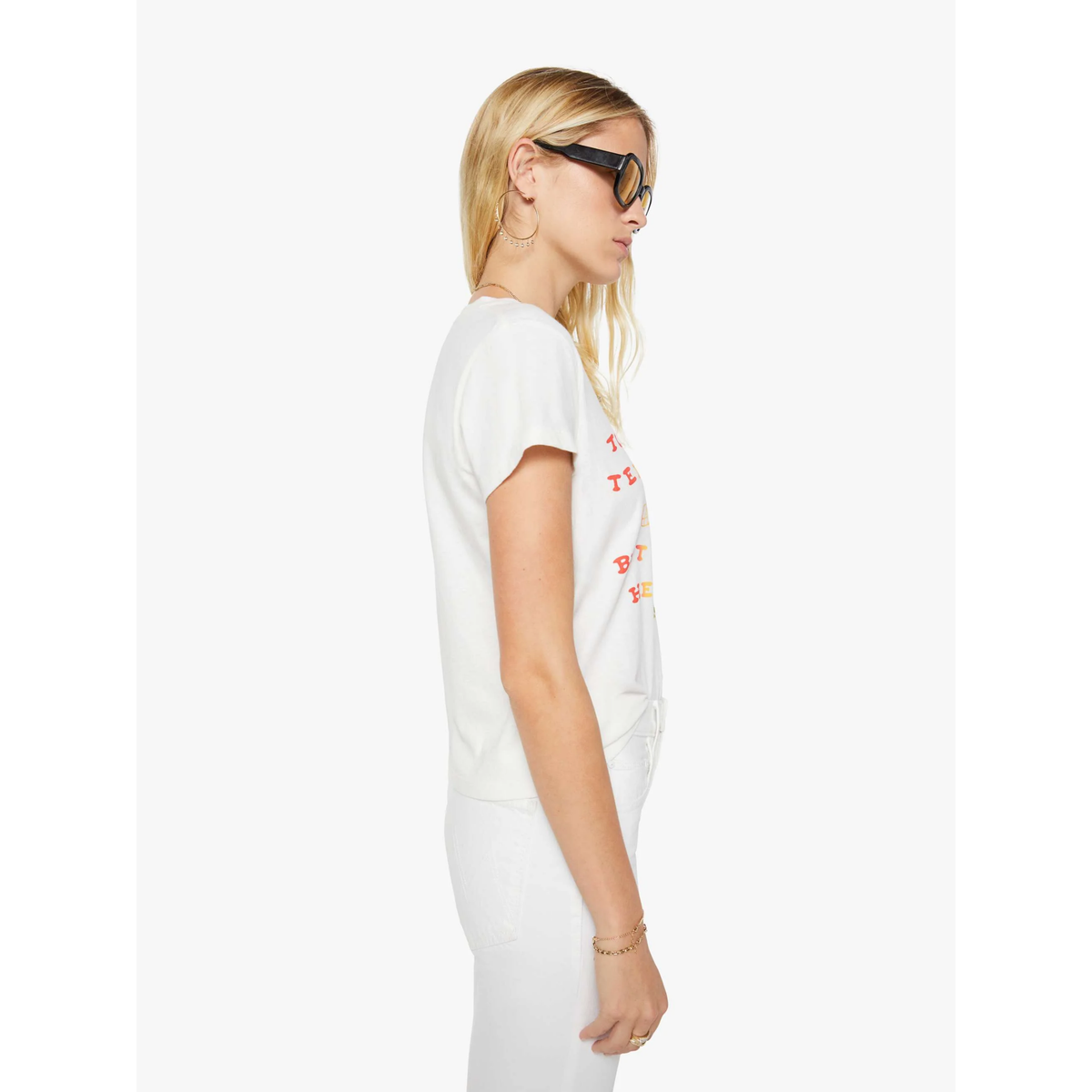 Woman wearing a white t-shirt with colorful graphics on a white background