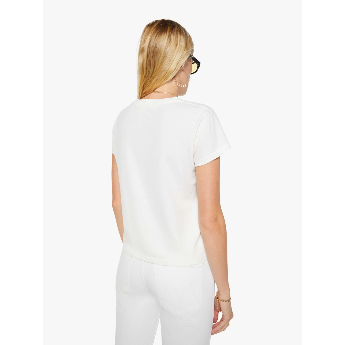 Woman wearing a white outfit on a plain background