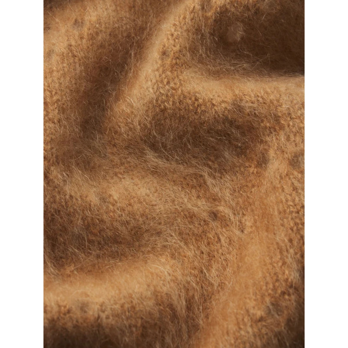A close-up of soft, fuzzy brown fabric with a warm camel or tan tone and visible texture.