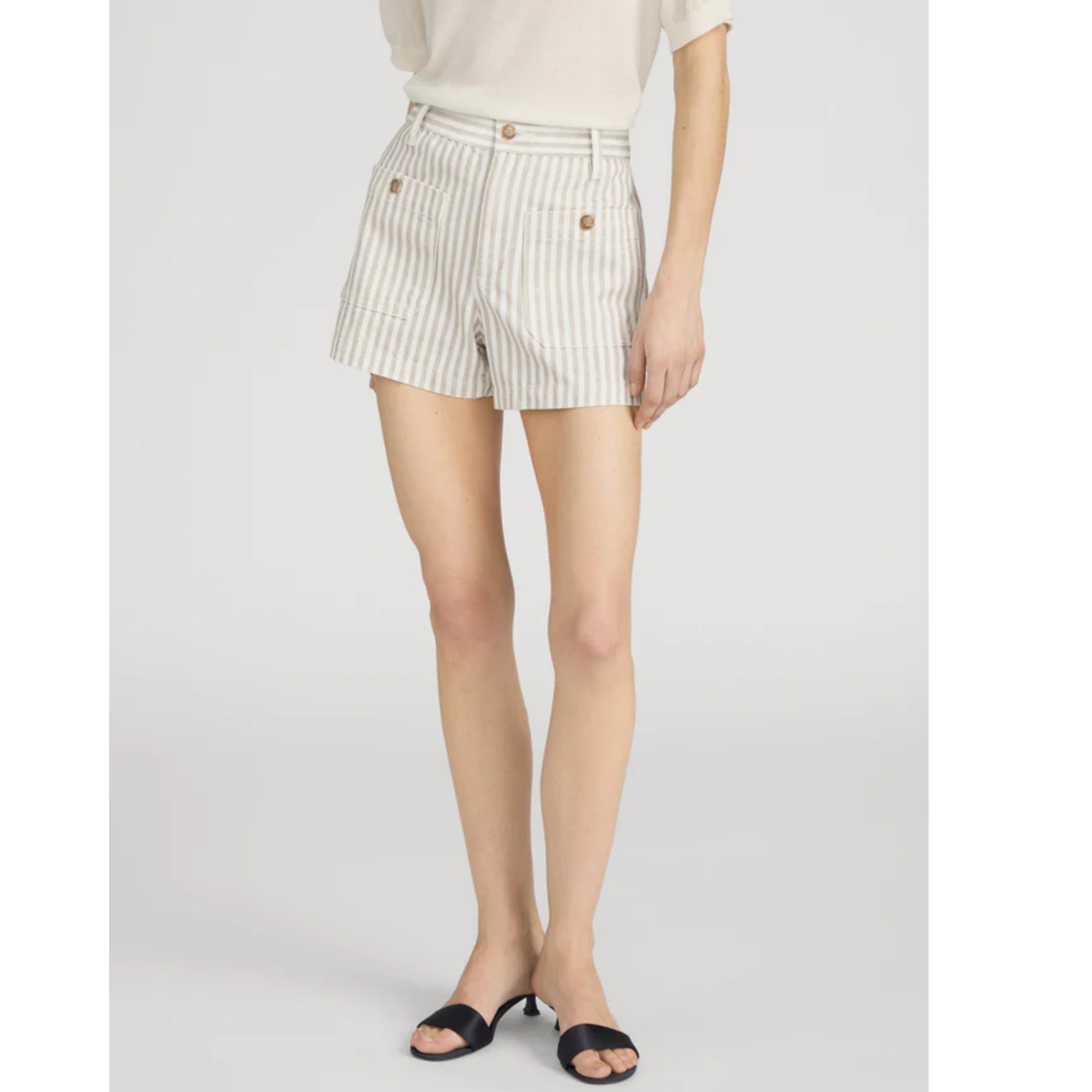 Person wearing white and green striped shorts on a light gray background
