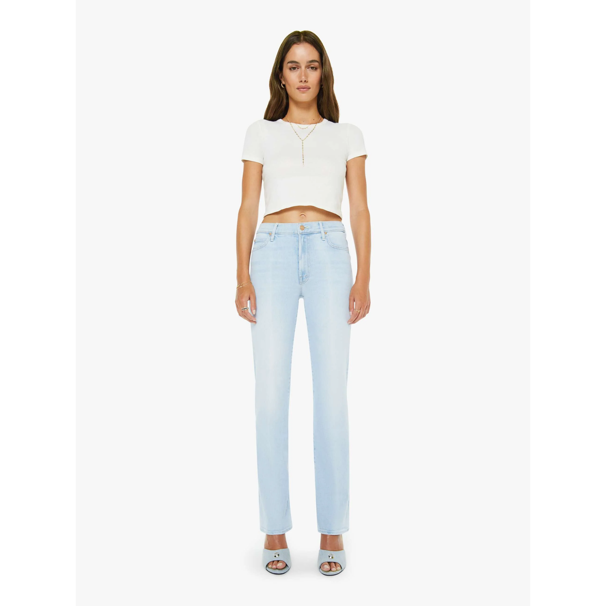 Woman wearing a white top and light blue jeans on a white background