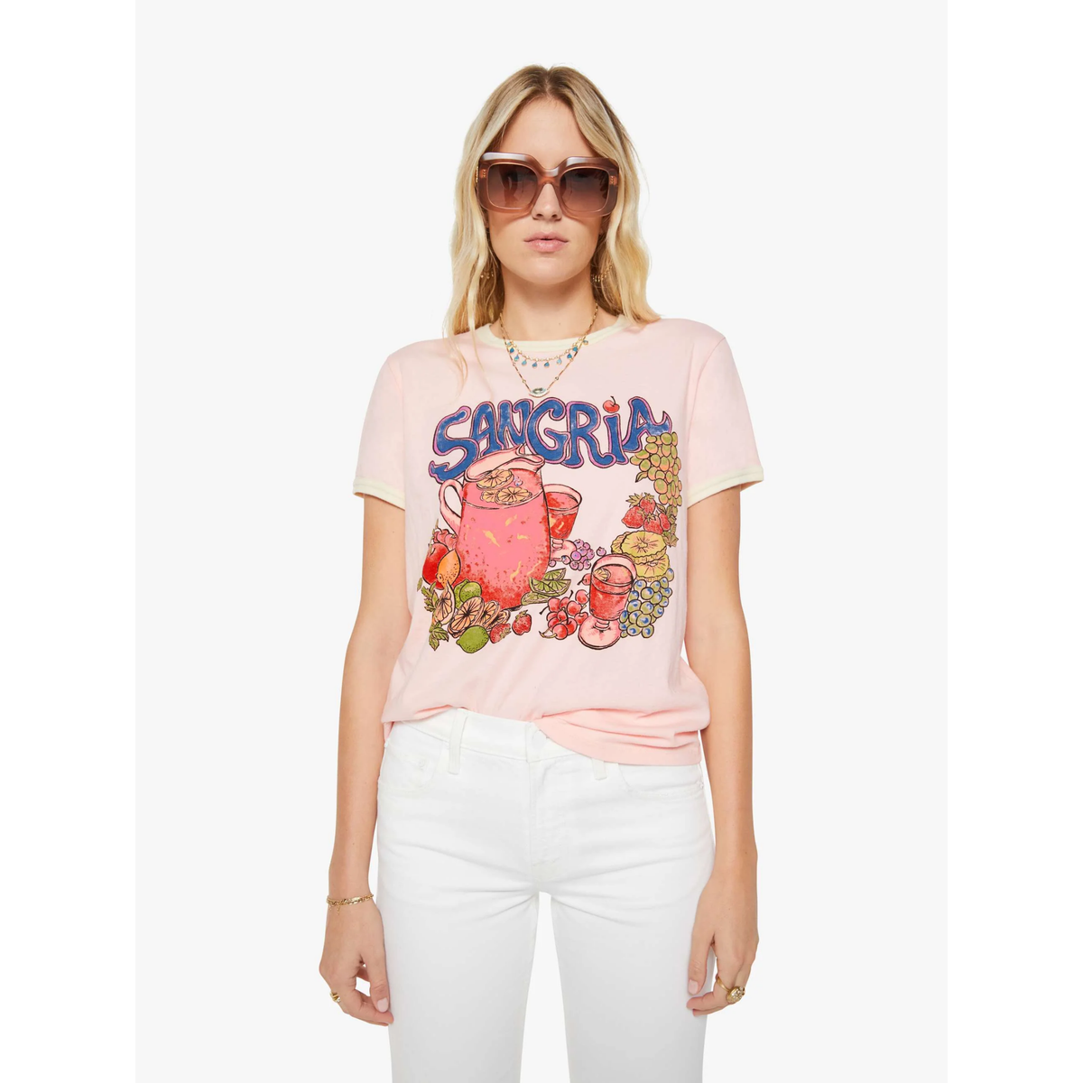 Woman wearing a pink t-shirt with 'Sangria' design and sunglasses on a white background