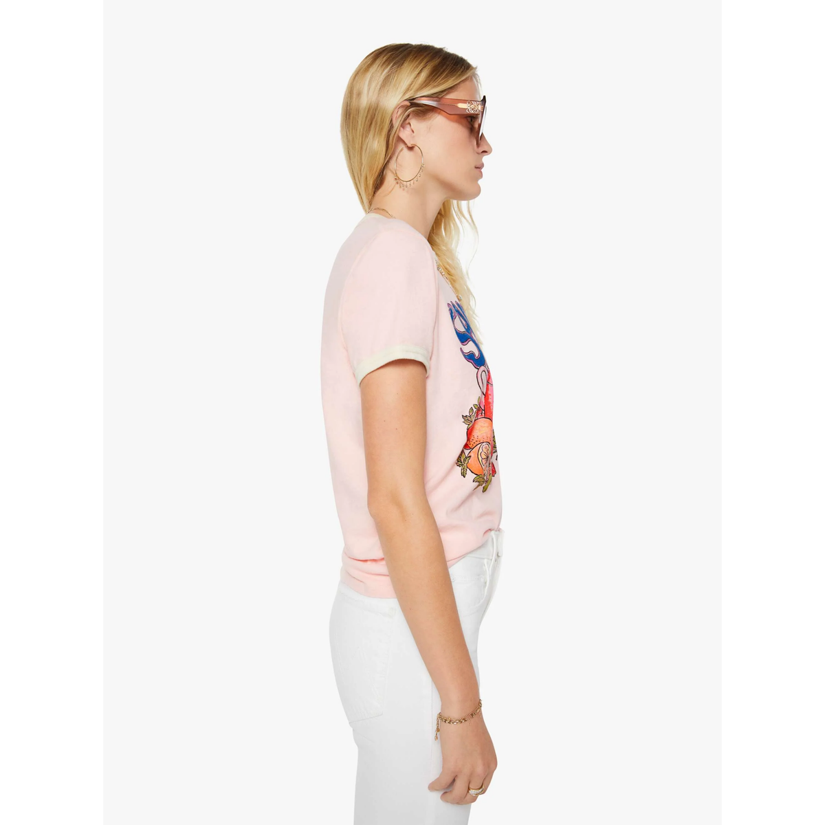 Woman wearing a pink t-shirt with a colorful graphic design on a white background