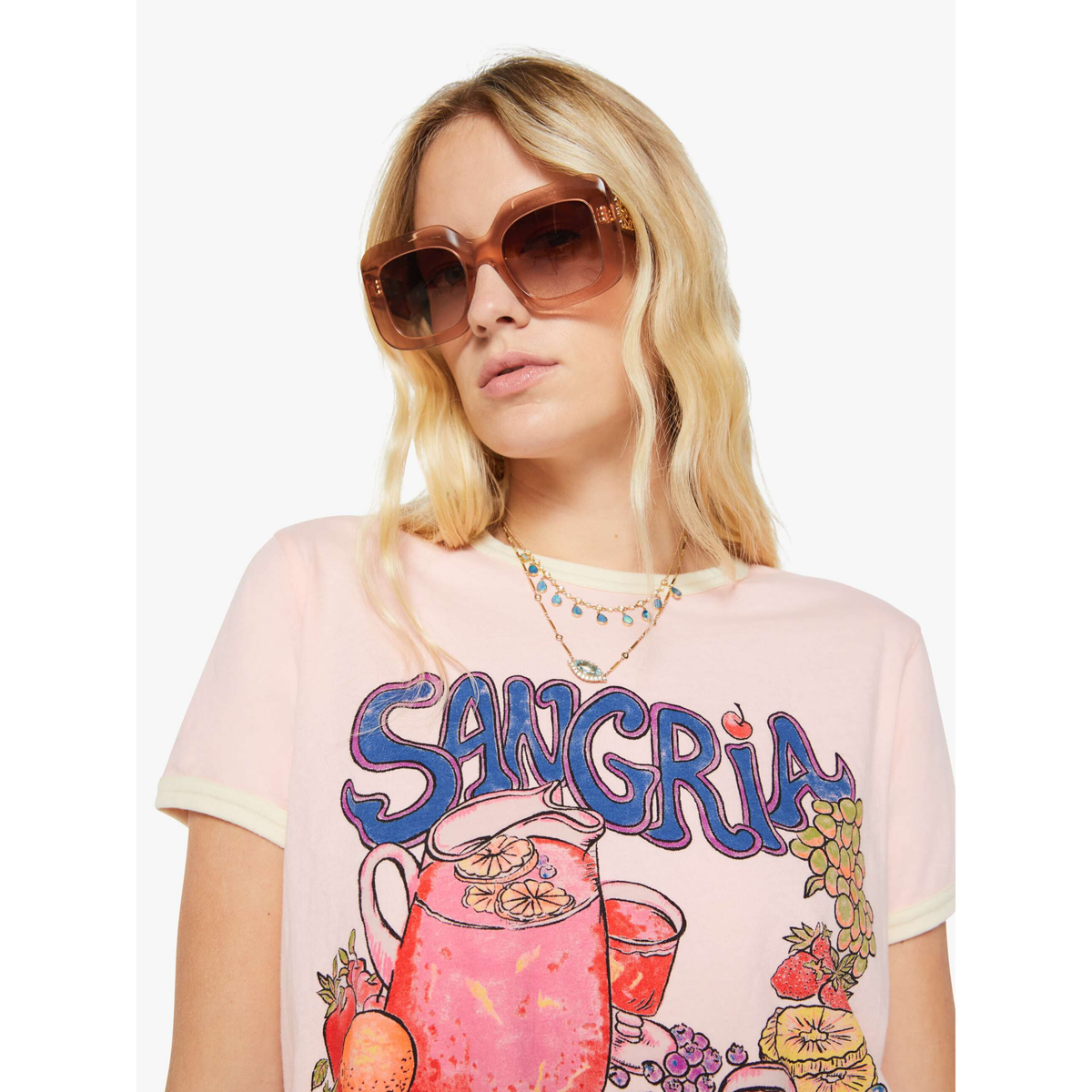 Woman wearing a 'Sangria' themed t-shirt with a pitcher and fruit design on a white background