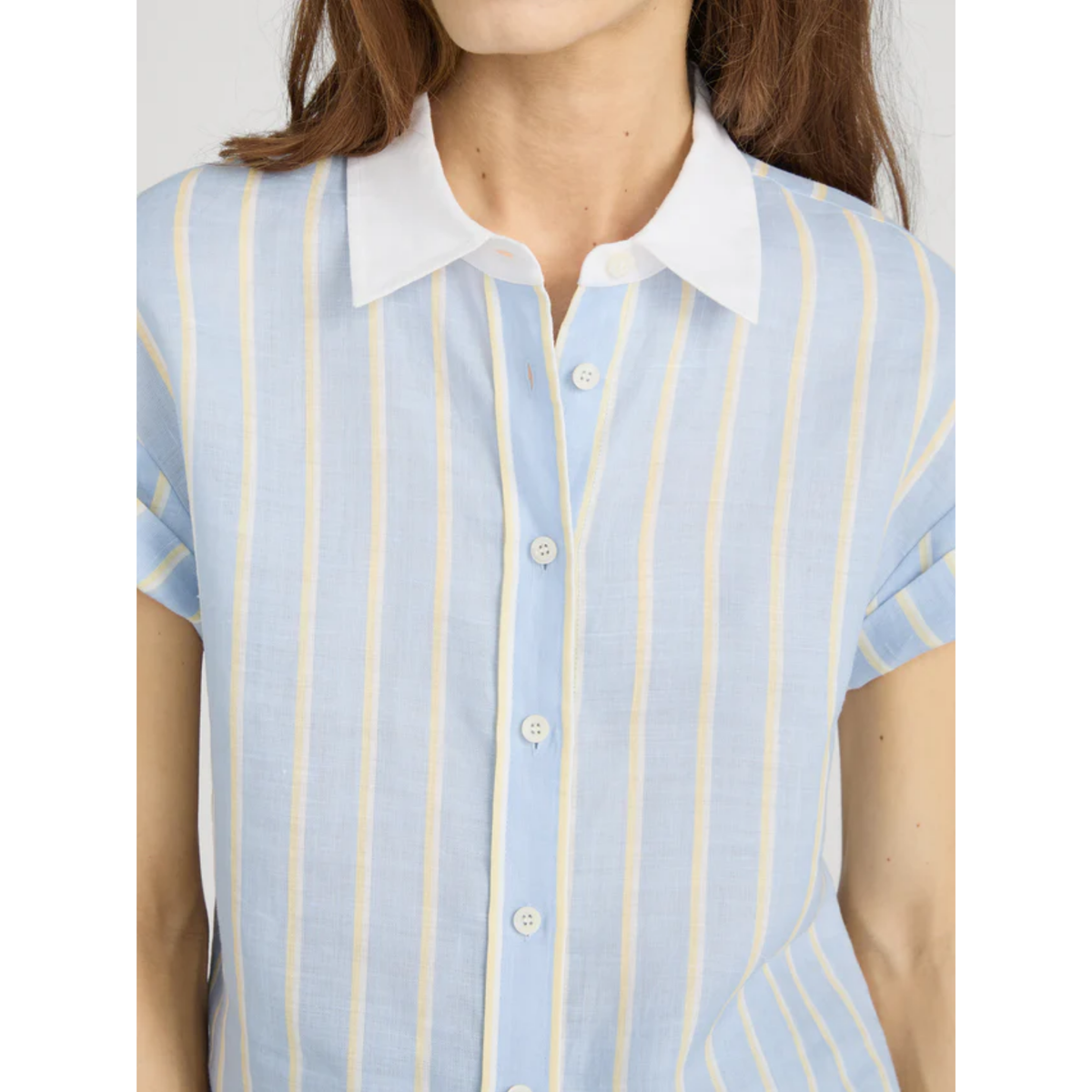 Light blue and yellow striped shirt worn by a person on a white background