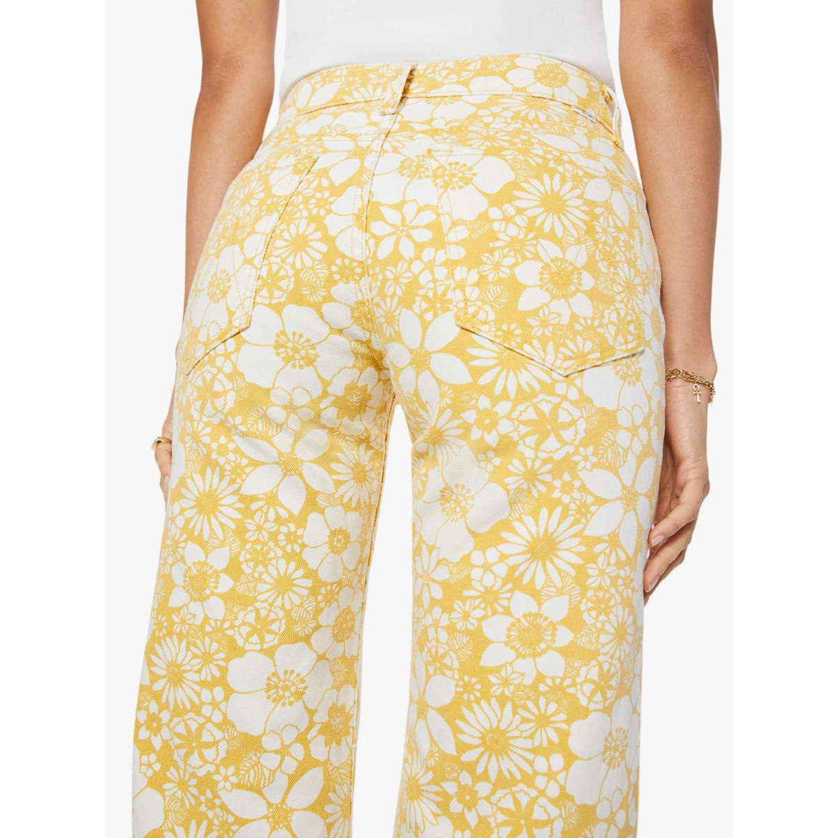 Yellow floral pants worn by a person on a white background