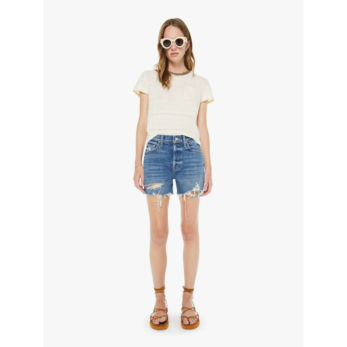 Woman wearing a white t-shirt and blue denim shorts on a white background