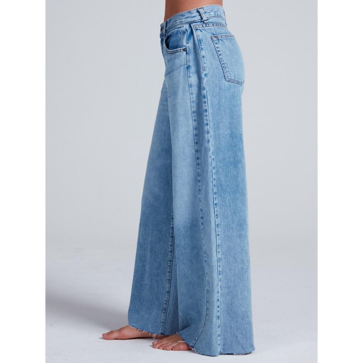 Light blue wide-leg jeans on a plain background