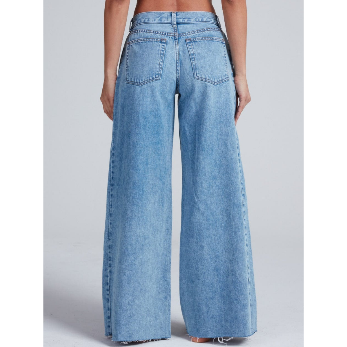 Light blue wide-leg jeans worn by a person on a plain background