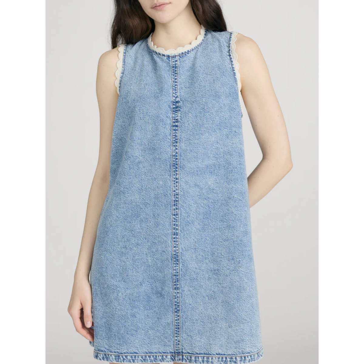 Light blue denim dress worn by a person on a white background