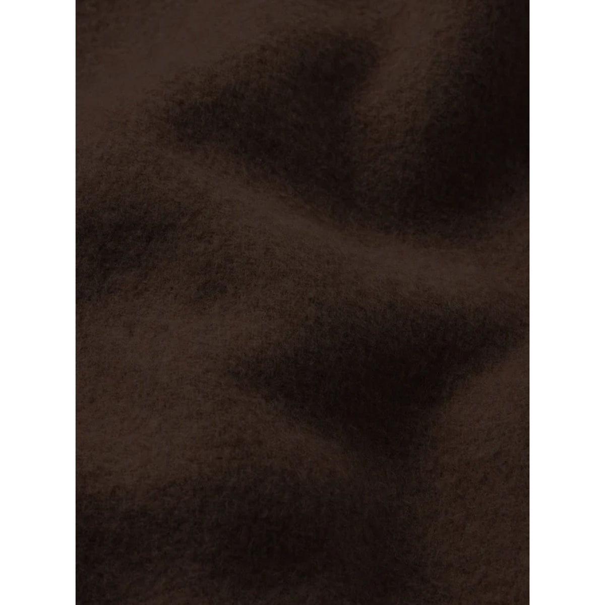 A close-up texture shot of a dark brown, soft, and slightly fuzzy fabric or material surface.