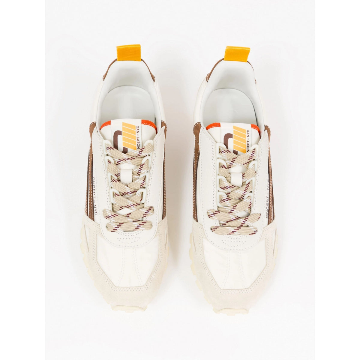 A pair of white and beige low-top sneakers with brown side panels, patterned laces, and bright yellow pull tabs, shown from a top-down view on a white background.