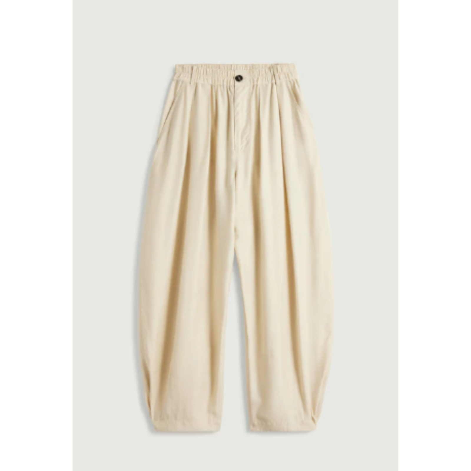 A pair of loose-fitting, cream-colored linen trousers with an elastic waistband and a small black button, displayed flat against a light gray background.