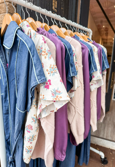 Rack of clothing outside of a boutique.